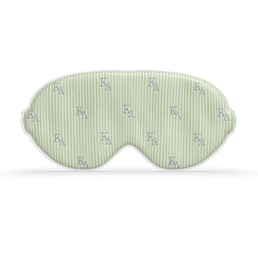 Green sleep mask with white stripes and ΚΔ letters on a white background