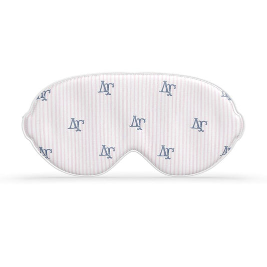 White sleep mask with blue ΔΓ letters on a white background