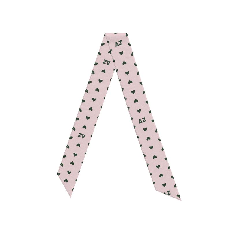 Pink twilly scarf with green heart patterns and Delta Zeta letters on a pink background