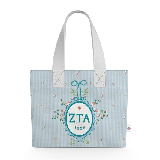 Tote bag with 'ZTA 1898' design on a light blue background
