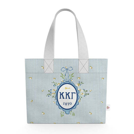 Tote bag with decorative design and text on a light blue background