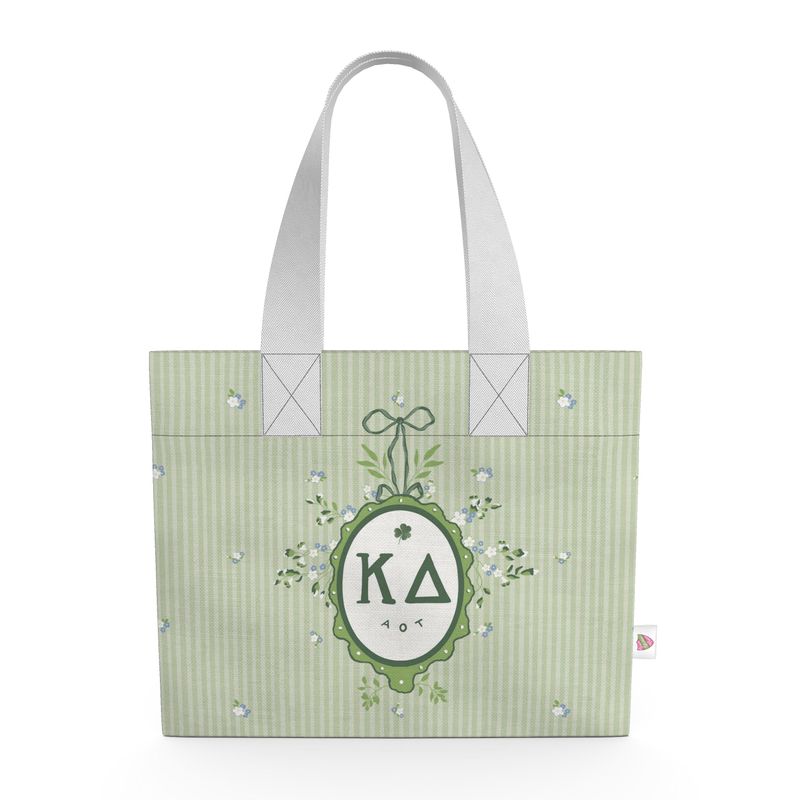 Green tote bag with decorative emblem and lettering on a white background